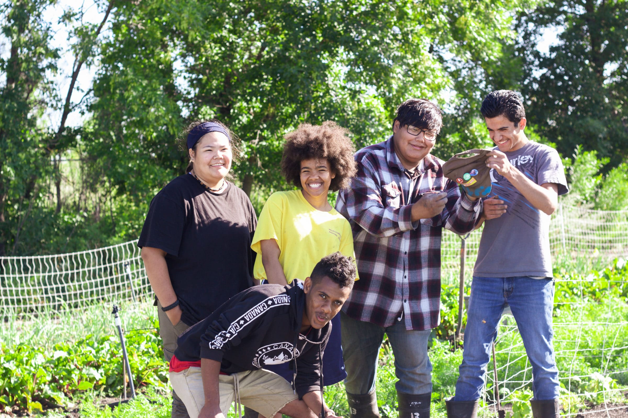 A group of youth posed in the field at FortWhyte Farms.
