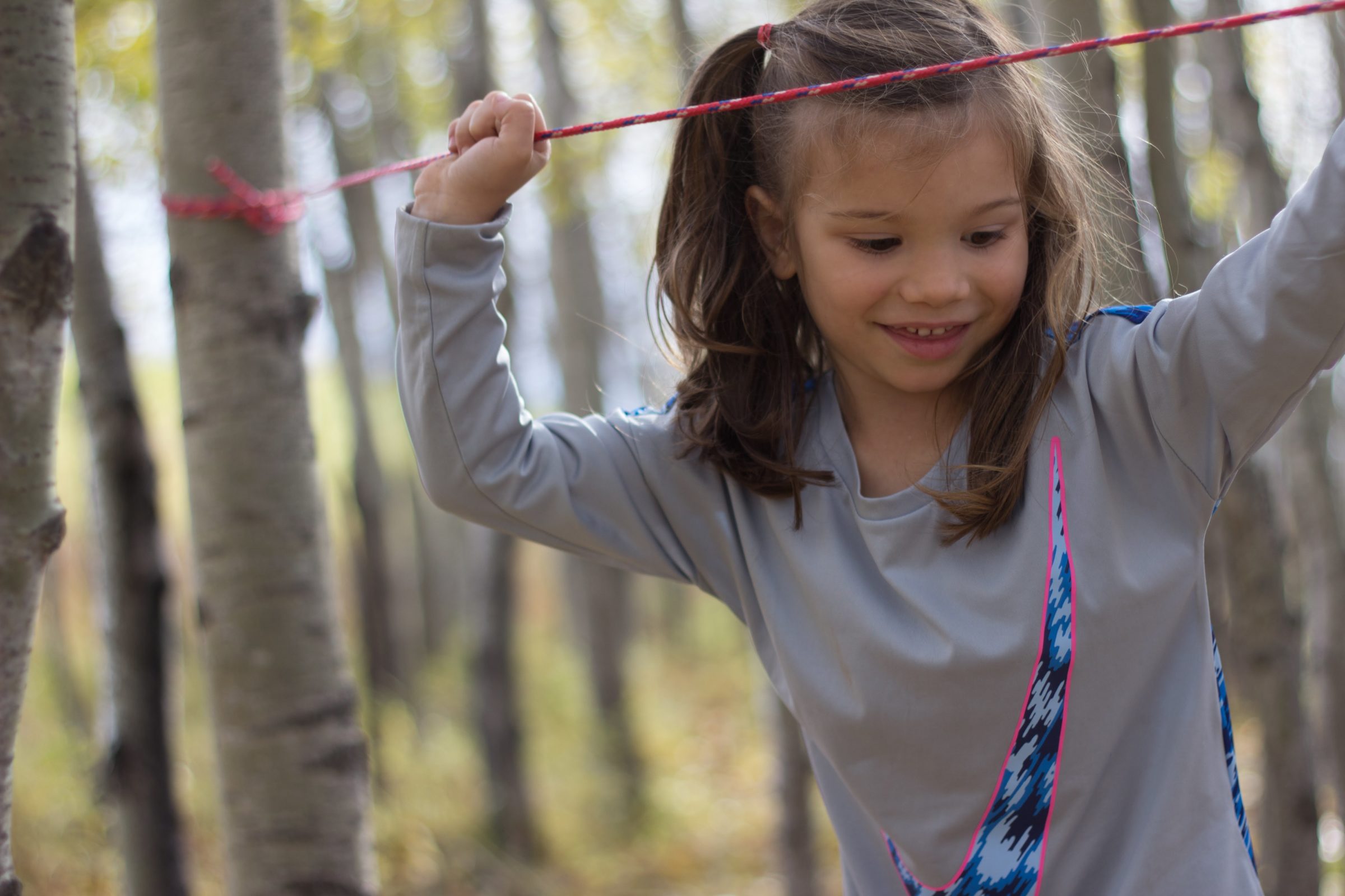 Young child playing in the forest in summer