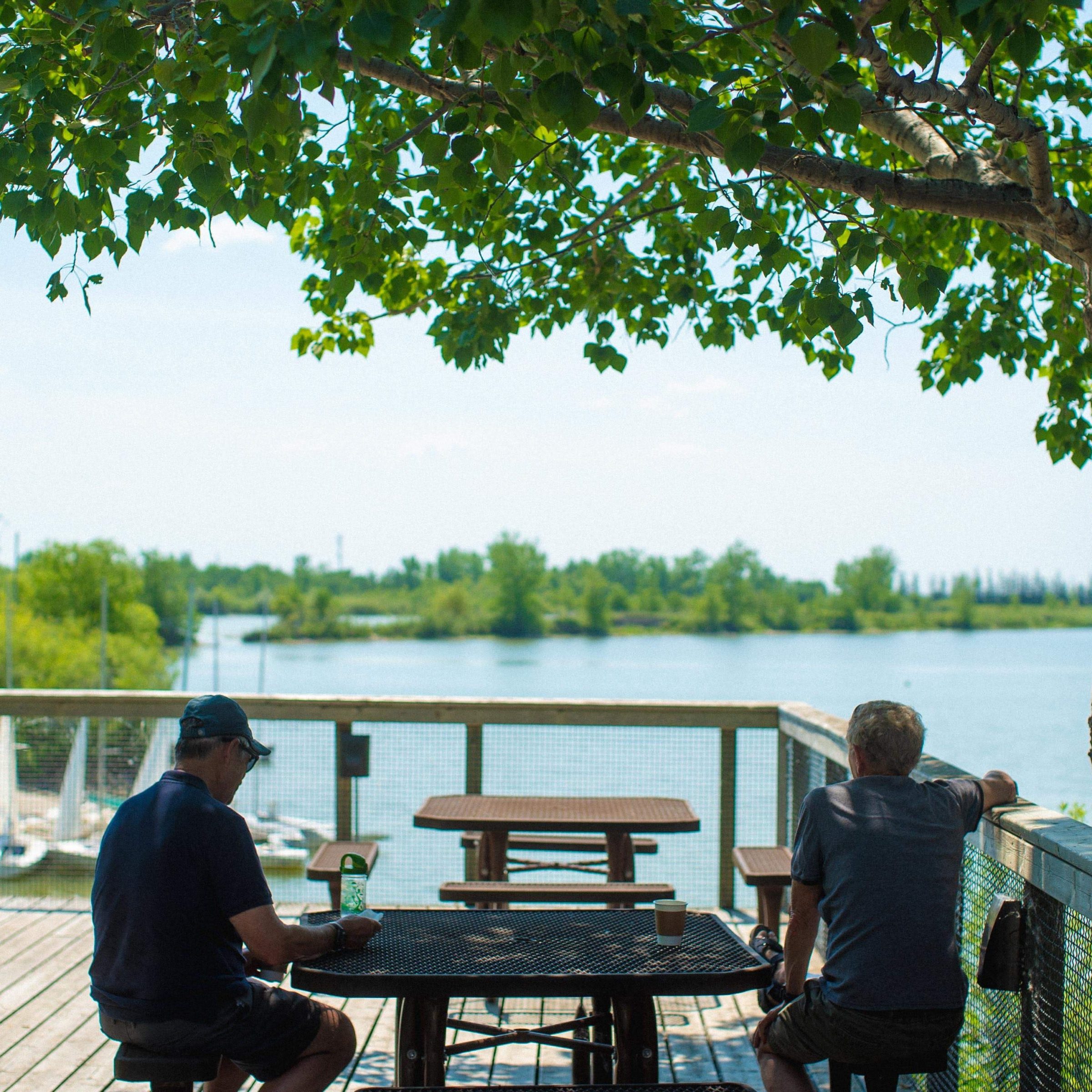 Two visitors sitting at a table on the deck of Buffalo Stone Cafe