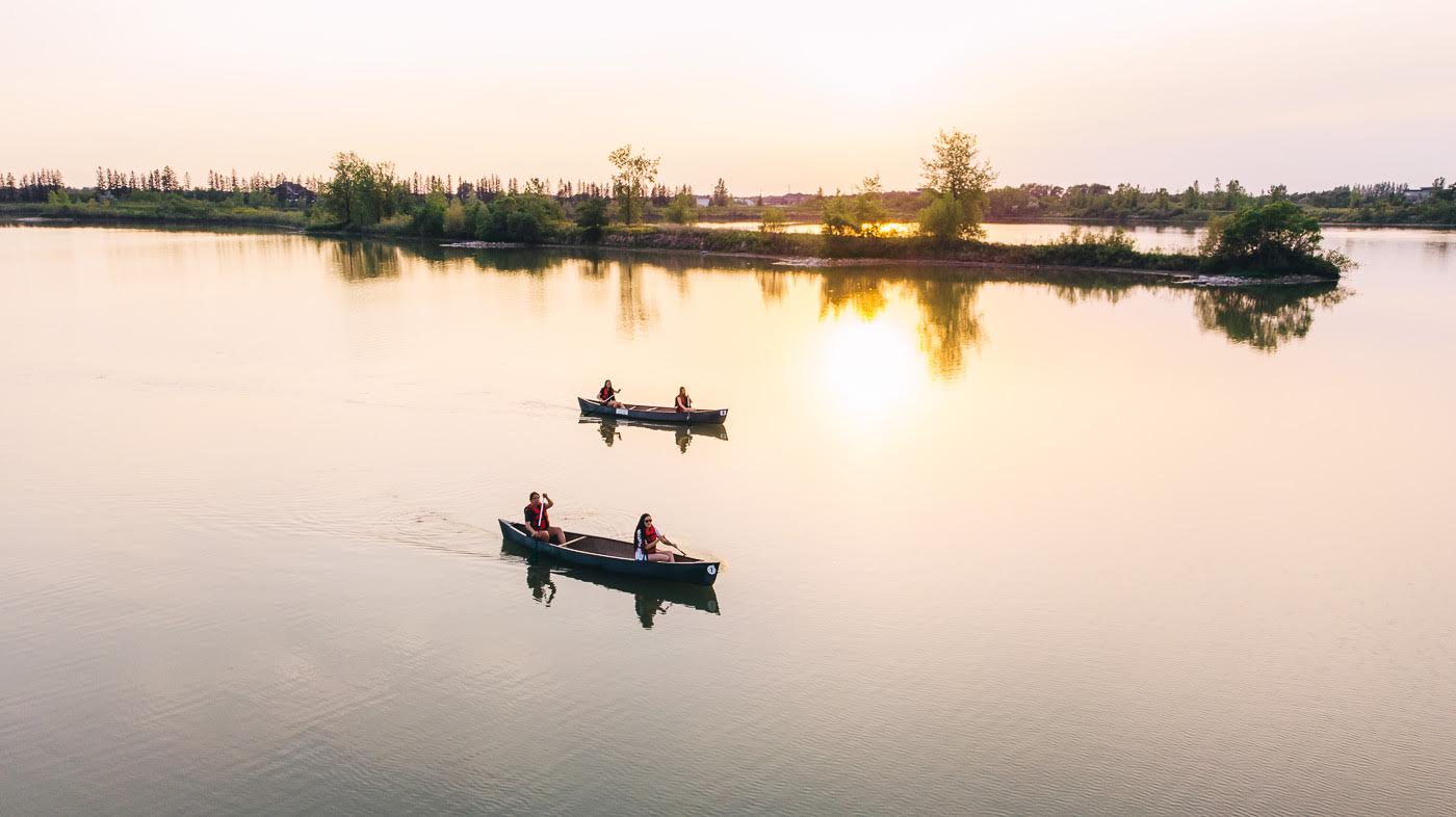 Two canoes out on the lake at sunset