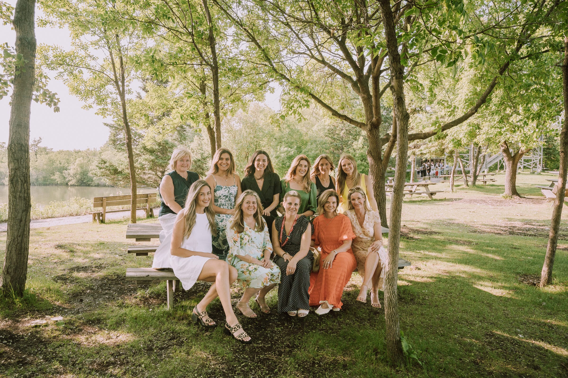 2023 Sunset BBQ planning committee poses on picnic bench
