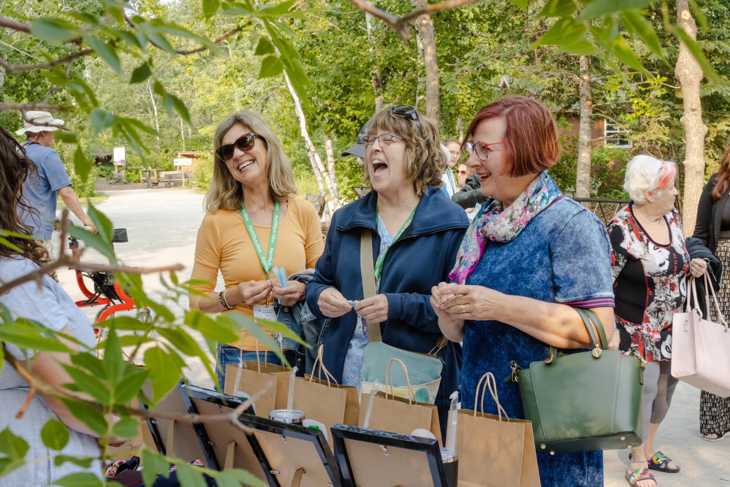 Volunteers smile and laugh at prize table at volunteer windup