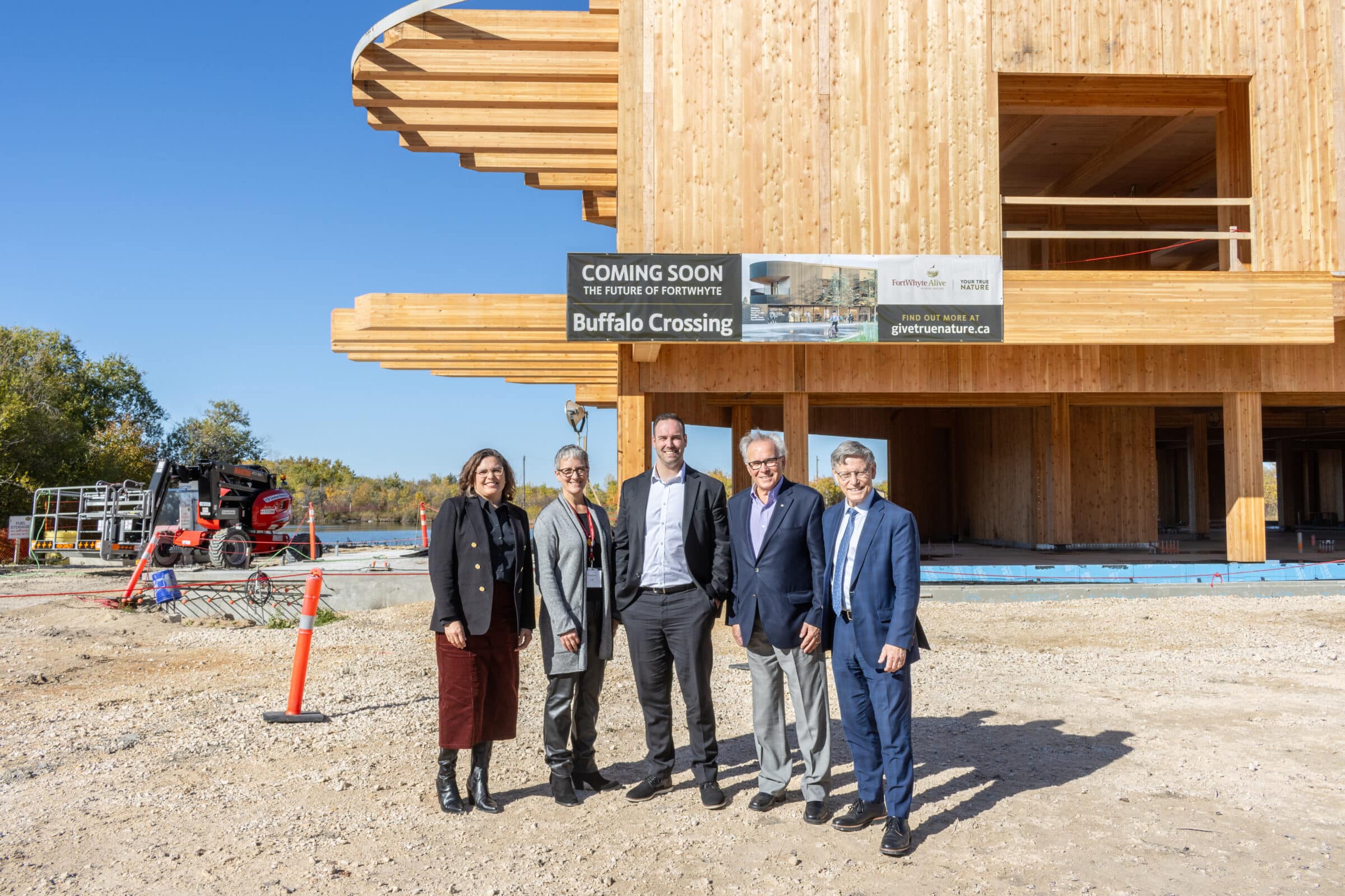 Ben Carr, Terry Duguid, Tanis Ostermann, Gary Filmon, and Liz Wilson stand in front of Buffalo Crossing building under construction