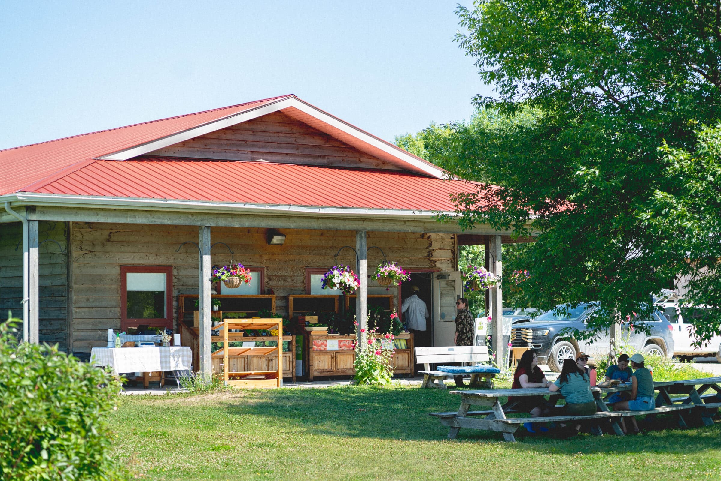 farm headquarters with people outside at table